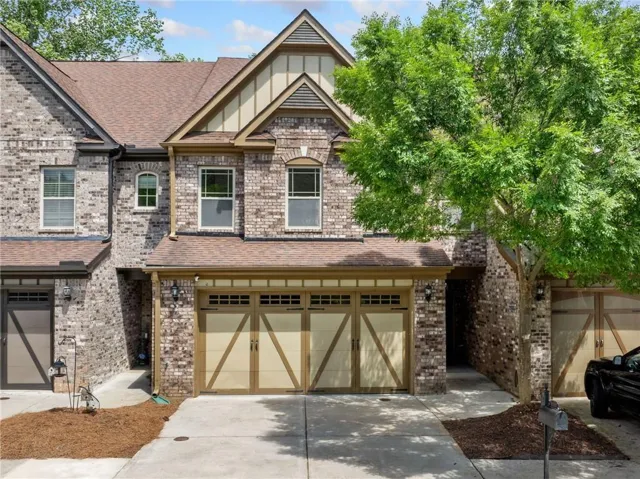 Striking brick and stone exterior with elegant architectural detailing and peaked rooflines