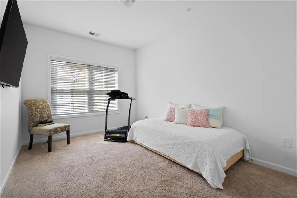 Carpeted bedroom featuring baseboards
