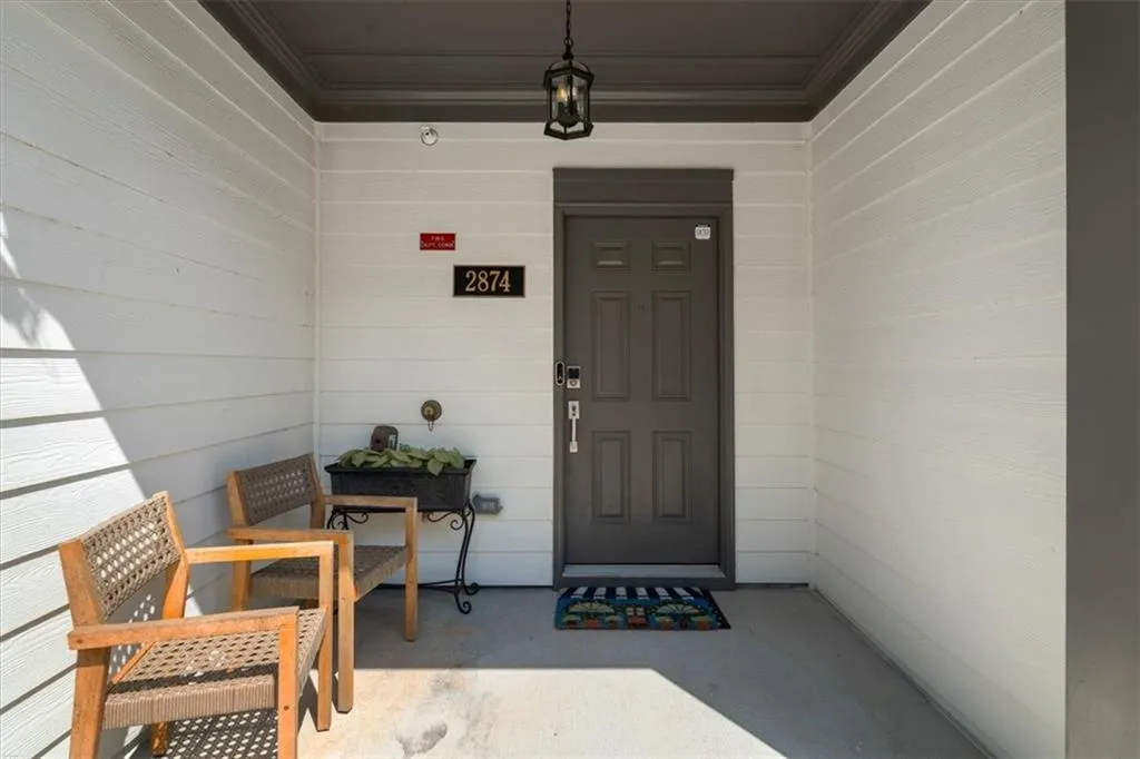 Entrance to property featuring covered porch