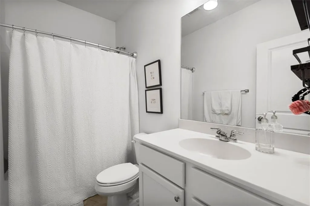 Bathroom with vanity and curtained shower