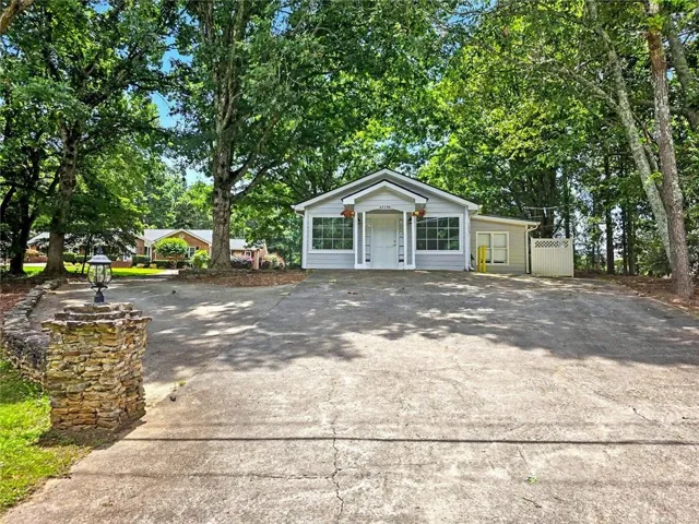 Single-story residence with light gray siding and white trim