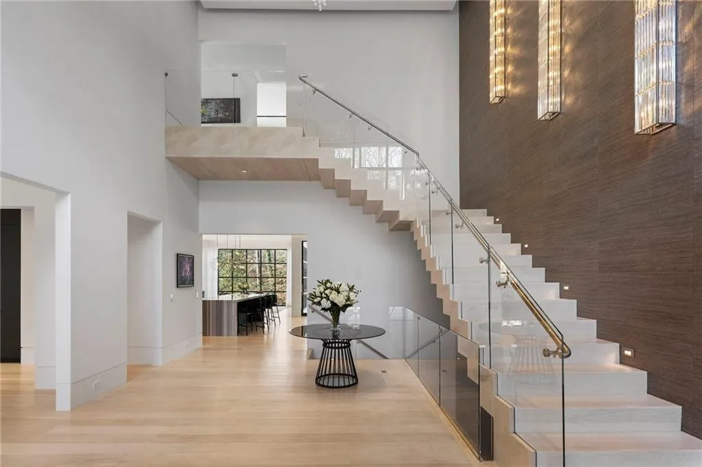 Dramatic two story entry. Solid custom stair design with glass railings.