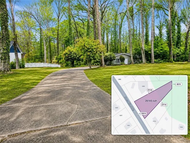 Paved driveway leading to a residence set among mature trees