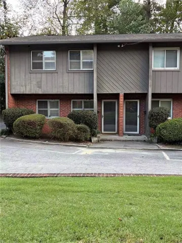 Brick and vertical siding exterior with multiple windows