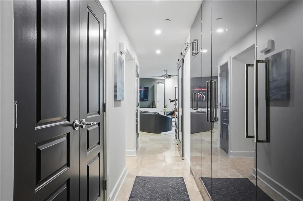 Entry foyer featuring floor to ceiling built-in storage cabinetry & decorator lighting