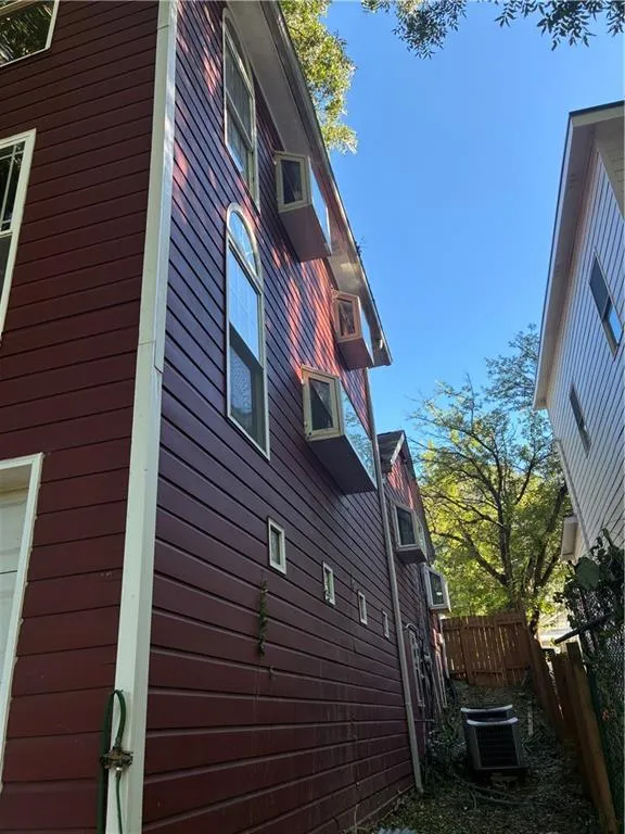 View of home's exterior with a central air condition unit and a garage