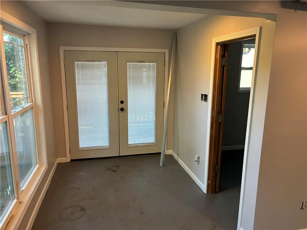 Entryway with french doors and unfinished concrete floors