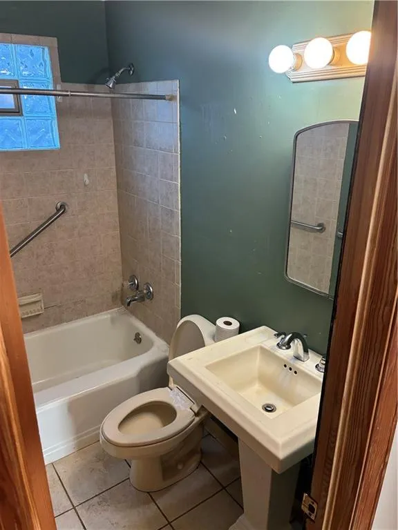 Full bath with  shower combination and tile patterned floors
