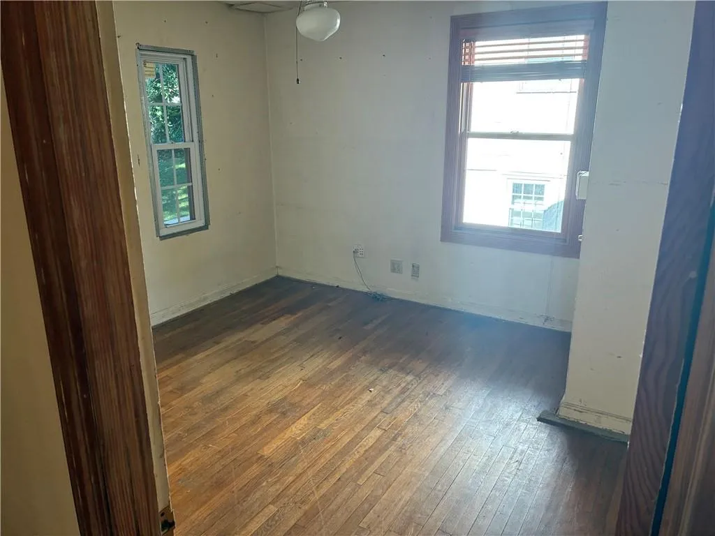 Empty room with dark wood-style floors