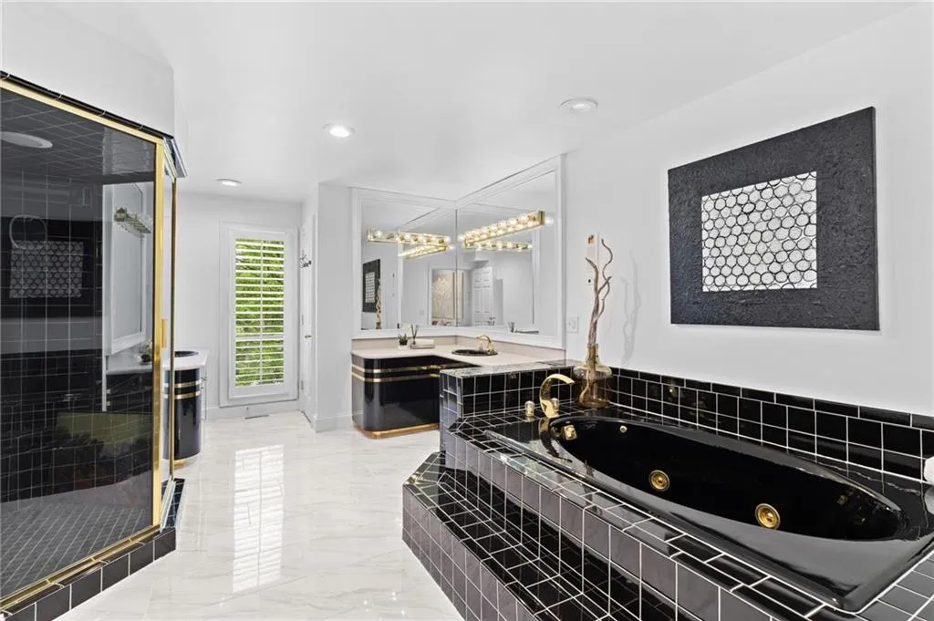 large primary bathroom complete with separate tub, shower, and private water closet