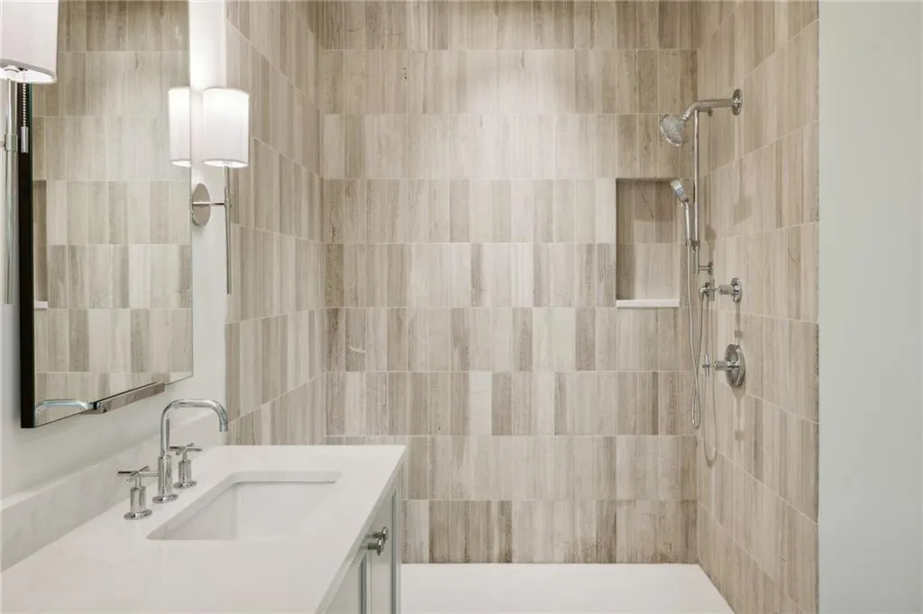Bathroom with vanity and a tile shower