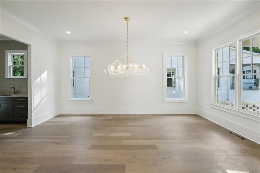 Unfurnished dining area with ornamental molding and a healthy amount of sunlight