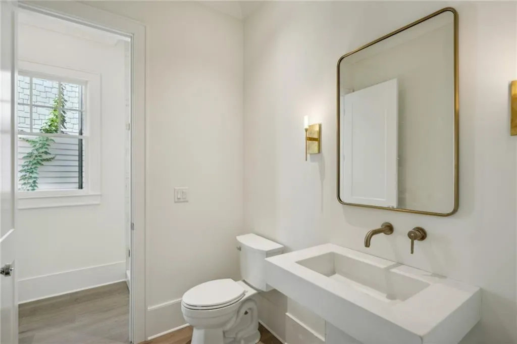 Bathroom featuring sink, hardwood / wood-style floors, and toilet