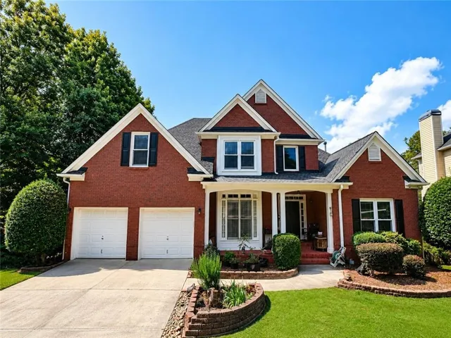Red brick exterior with white trim details and black shutters