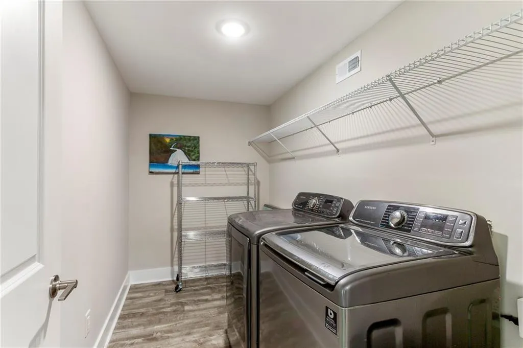 Laundry area featuring hardwood / wood-style flooring and independent washer and dryer
