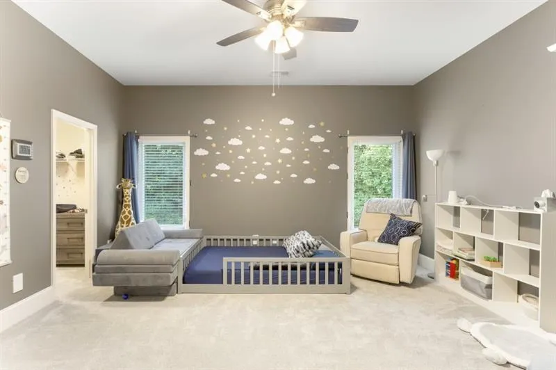 Living area featuring carpet floors and ceiling fan