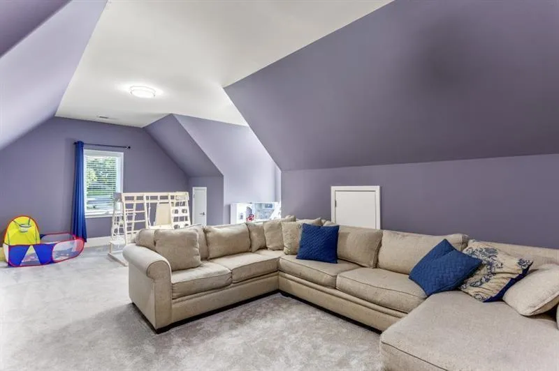 Living room with lofted ceiling and carpet