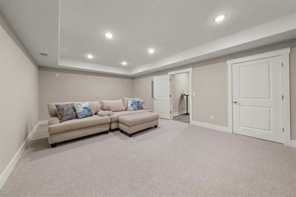 Living room featuring light colored carpet and a tray ceiling