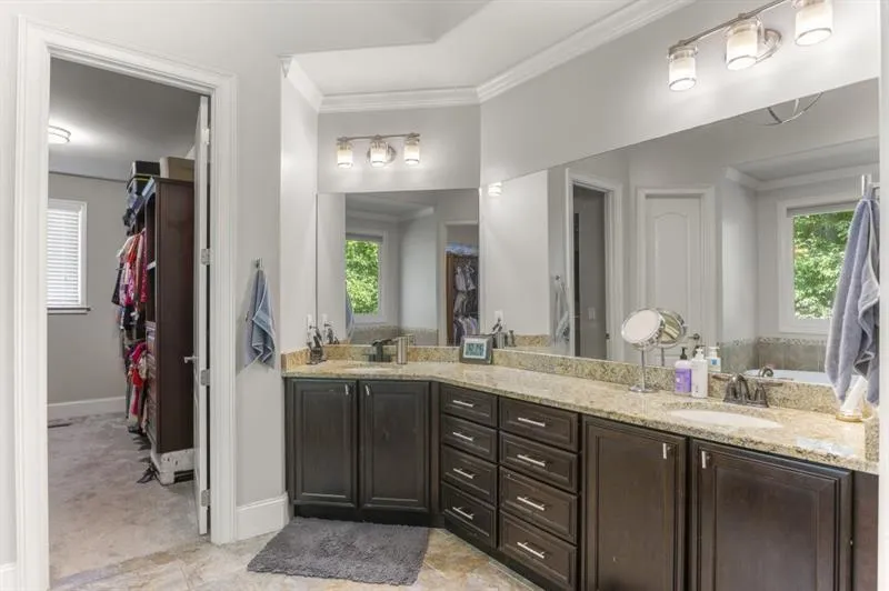 Bathroom featuring vanity and ornamental molding