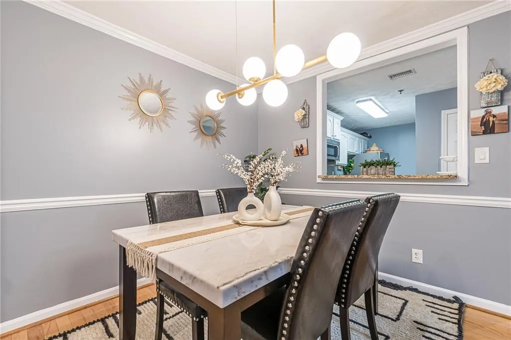 Dining area featuring light wood-style flooring and ornamental molding