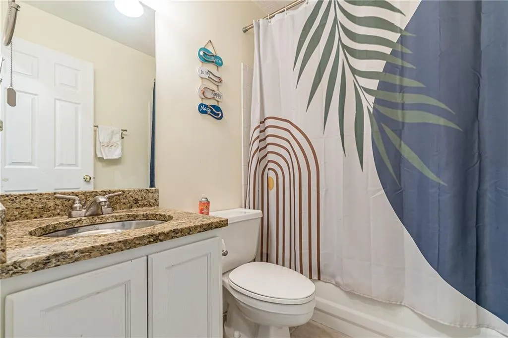 Full bath featuring vanity and shower / bath combo with shower curtain