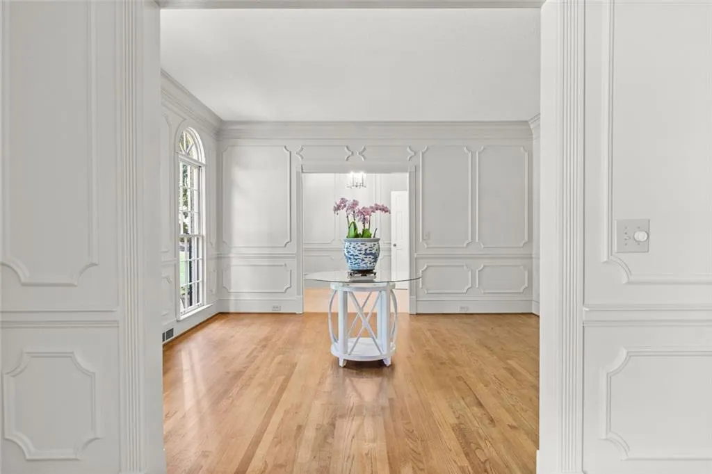 View of continuing Millwork from Dining to Living, to Entry Hall