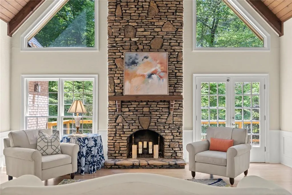 Featuring the natural light and stone fireplace