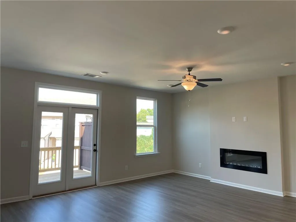 The living room has double doors that lead out onto the deck.
