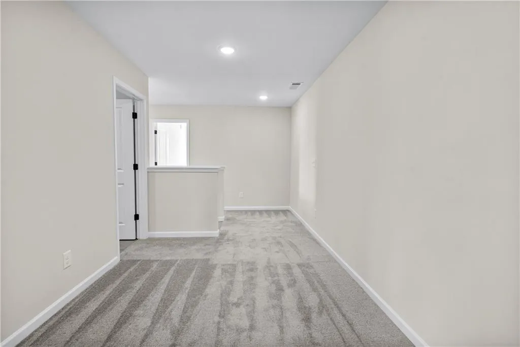 Spare room featuring light carpet and recessed lighting