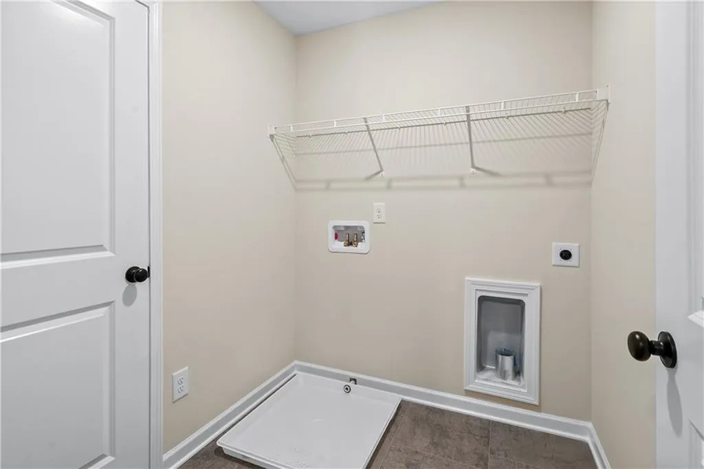 Laundry room with hookup for a washing machine and electric dryer hookup