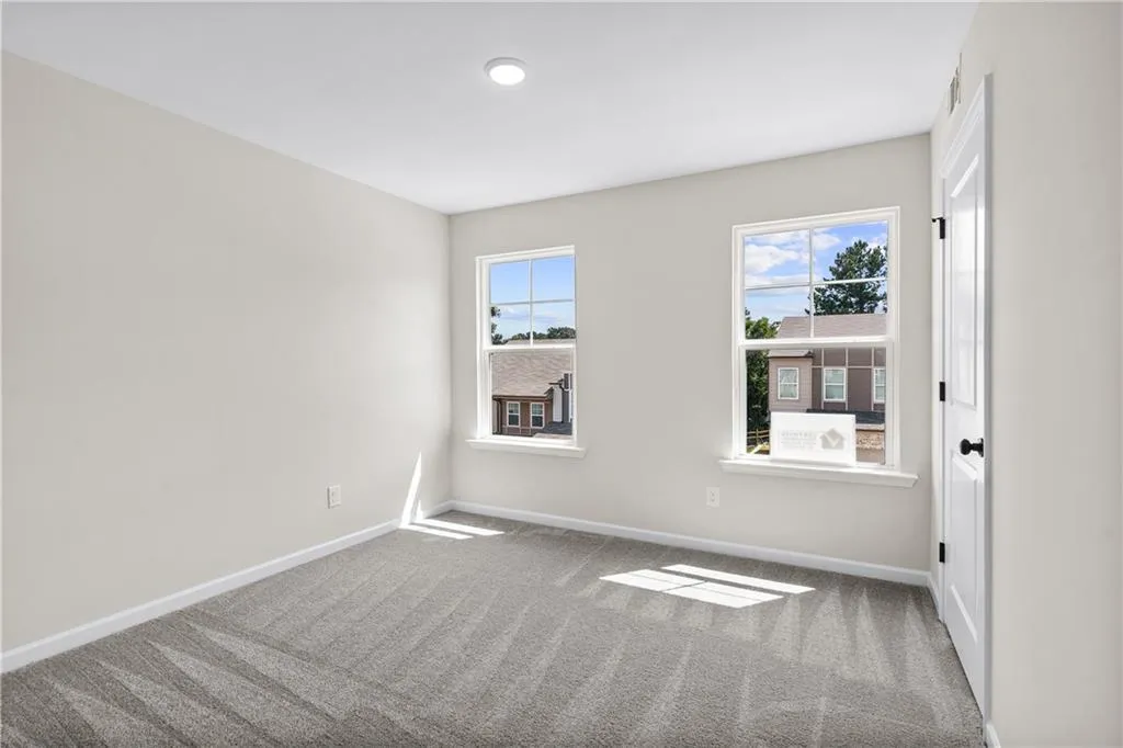 Carpeted empty room with healthy amount of natural light