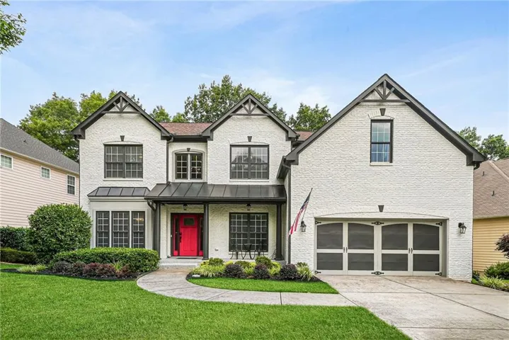 White brick exterior with prominent gables and dark trim accents