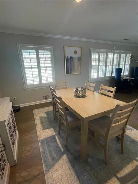 Dining room featuring ornamental molding and baseboards