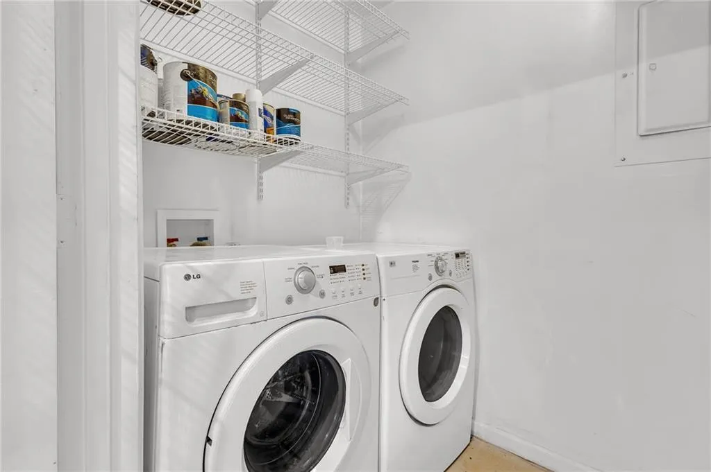 Laundry area with washing machine and clothes dryer and electric panel