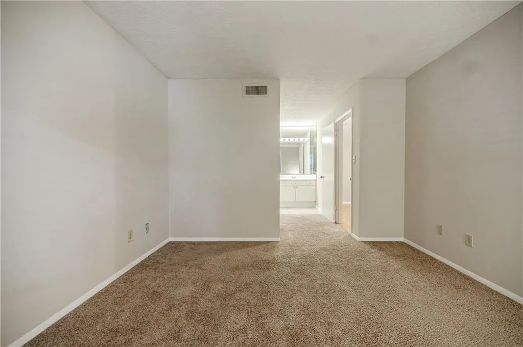 Bedroom featuring carpet floors and a textured ceiling
