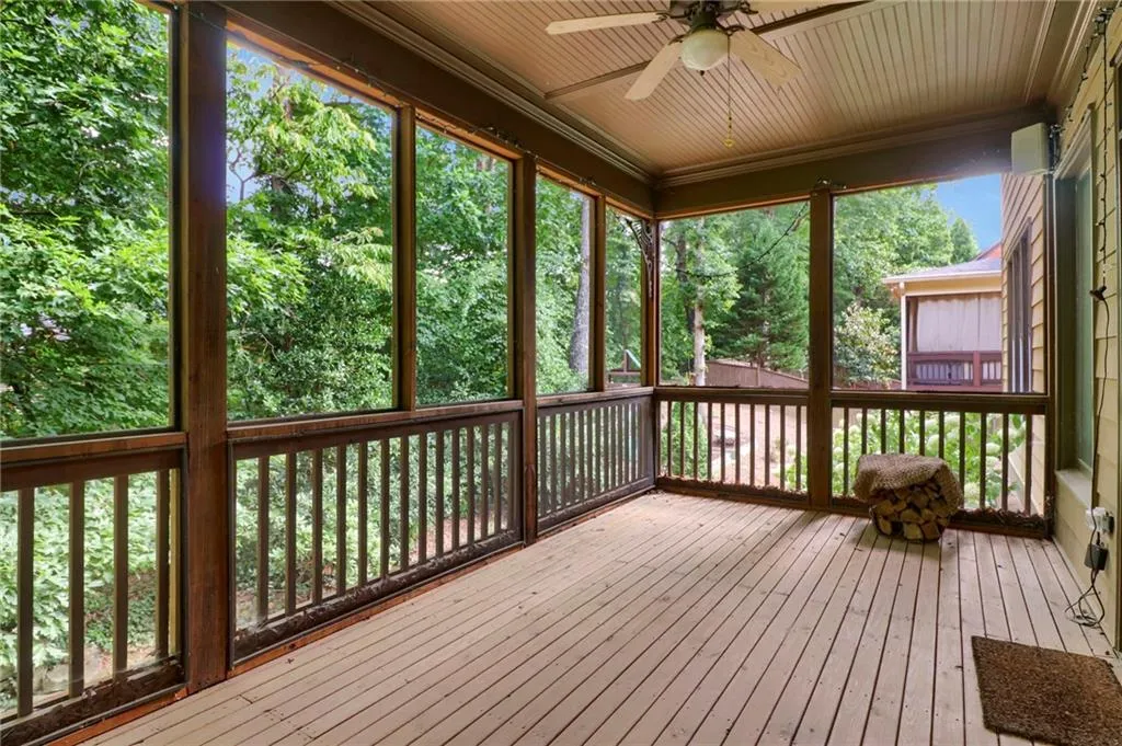 Unfurnished sunroom with a ceiling fan and healthy amount of natural light