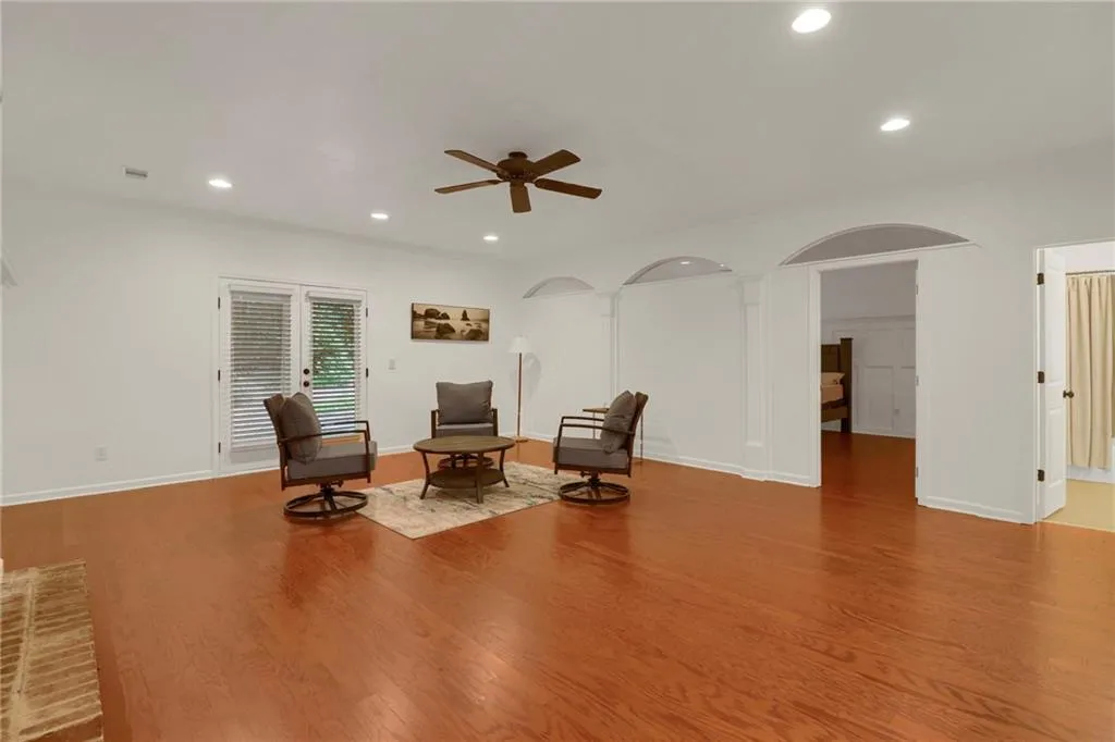 Sitting room featuring recessed lighting, wood finished floors, a ceiling fan, and arched walkways