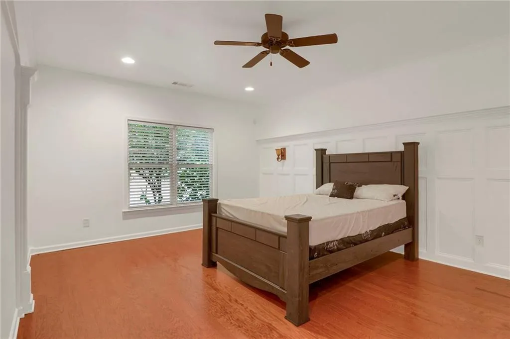 Bedroom with light wood-style floors, recessed lighting, and a ceiling fan