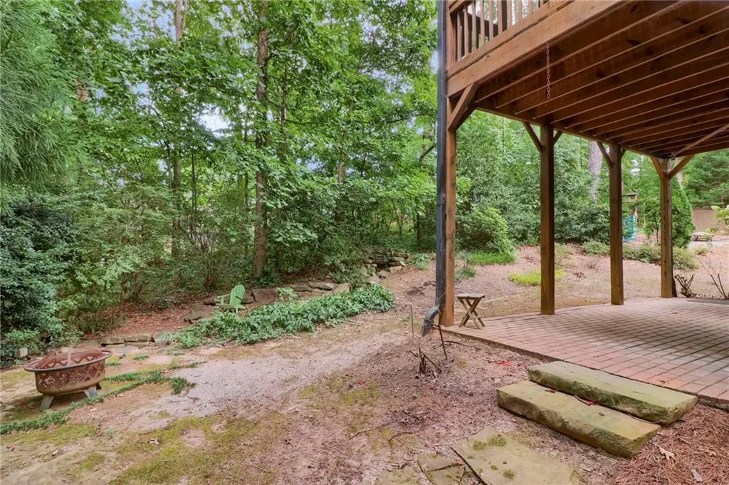 View of yard with an outdoor fire pit, a patio, and a wooden deck