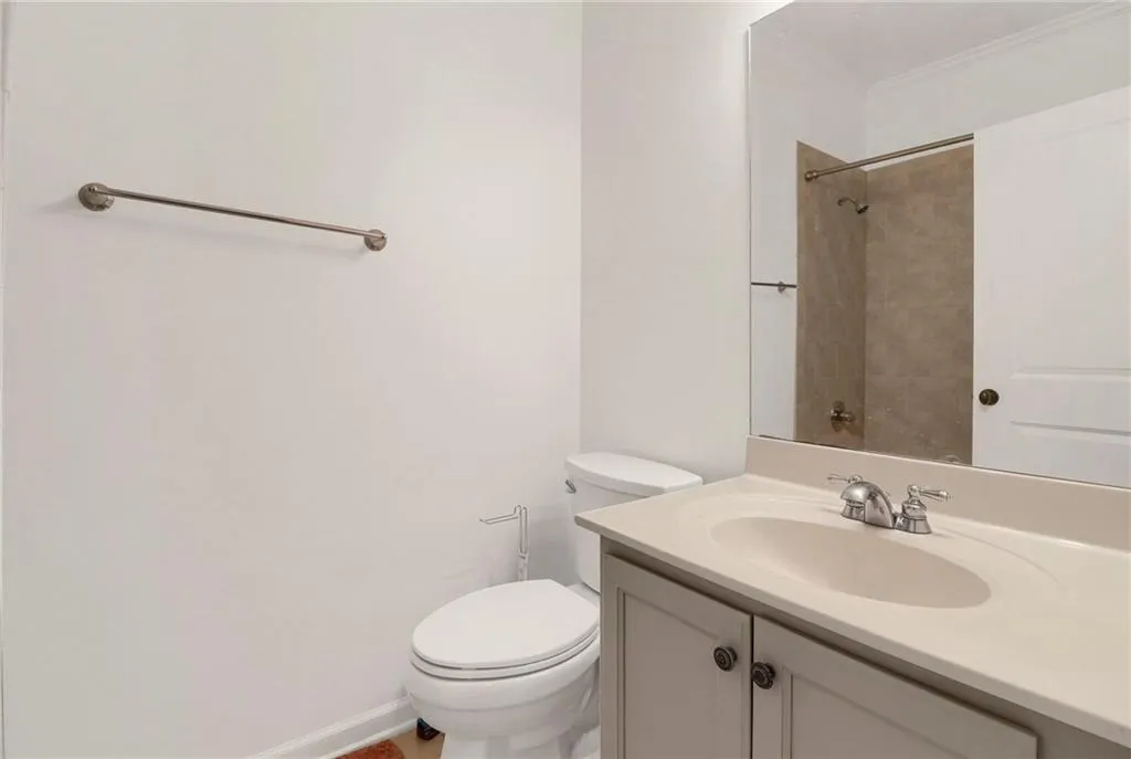 Full bath with vanity, a shower, and ornamental molding
