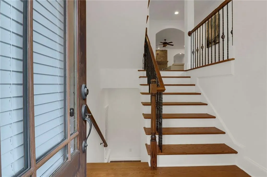 Staircase featuring wood finished floors