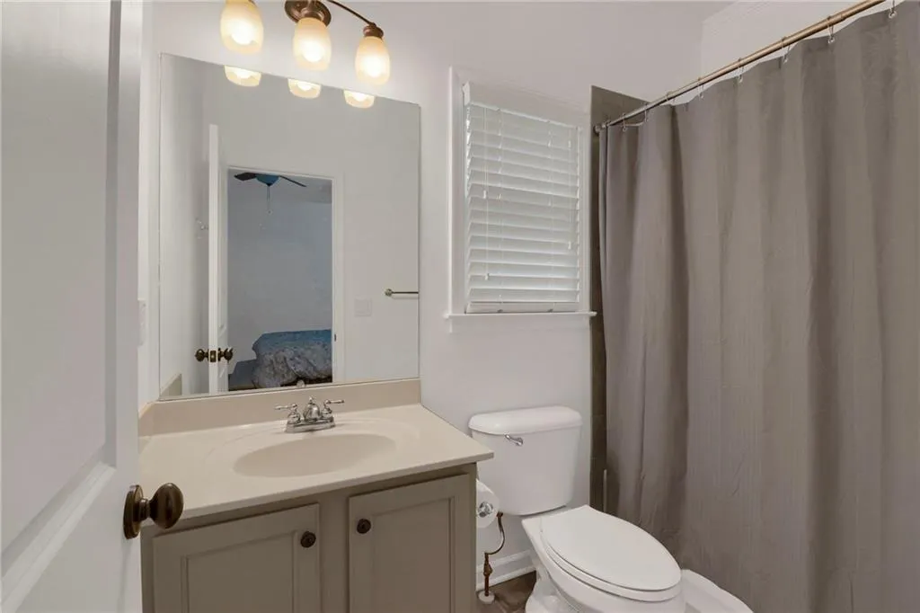 Bathroom with vanity, ensuite bath, and curtained shower