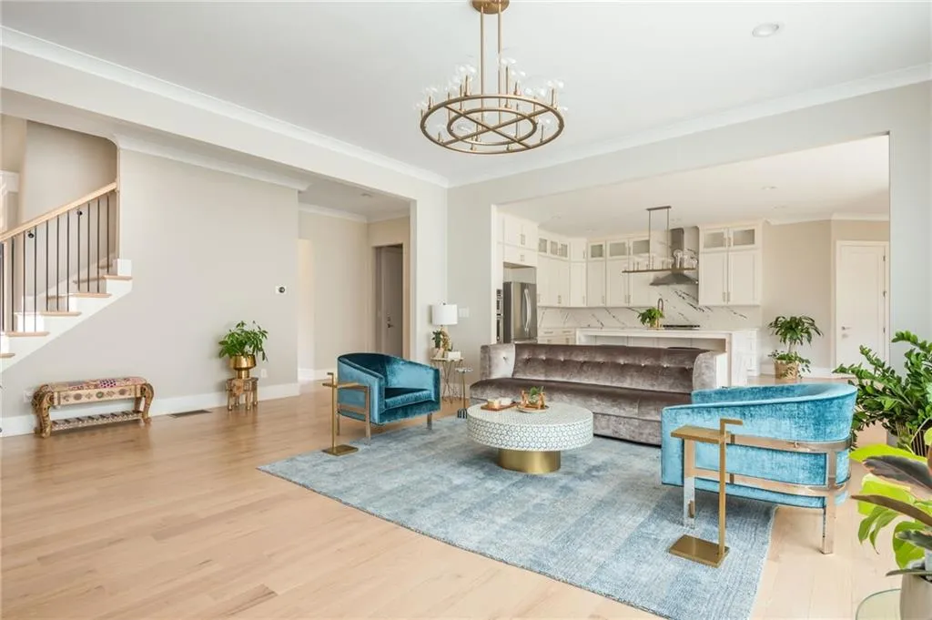 Family room featuring  a notable chandelier, and open concept kitchen