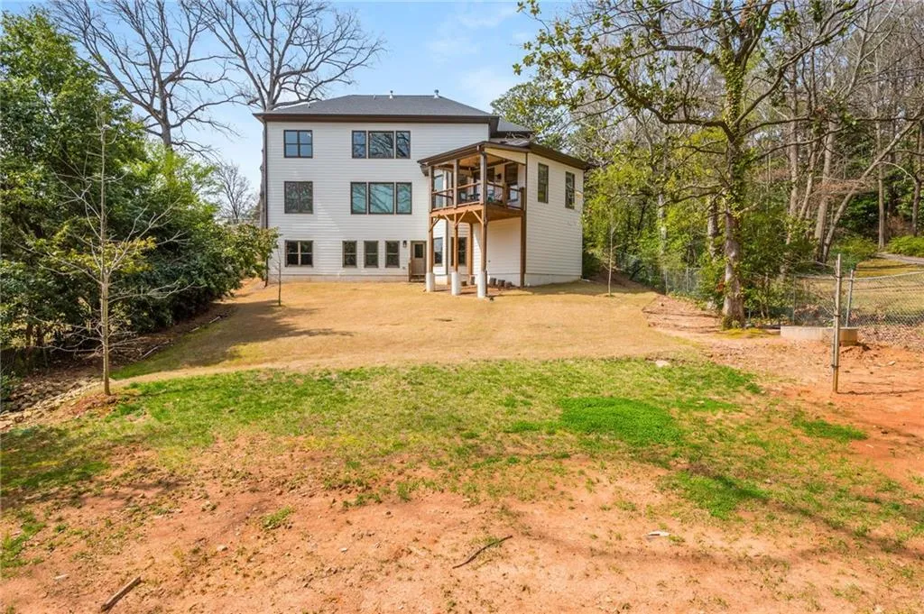 Rear view of house featuring a yard