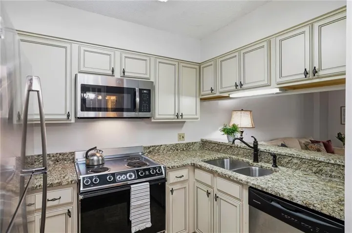 Stainless appliances, granite countertops, European-style cabinets