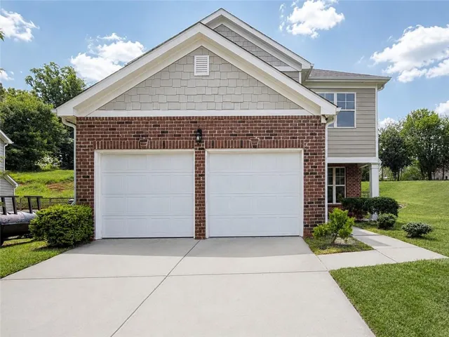 Two-car garage with white paneled doors
