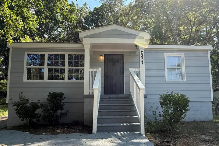 Light blue siding exterior with white trim and a covered front entry