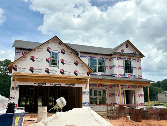 Two-story construction featuring a gable roofline, multiple windows, and a covered front entry