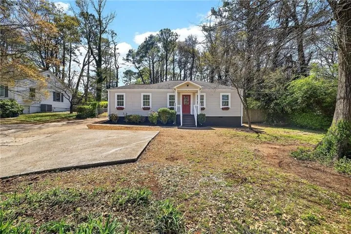 Single-story residence featuring light gray siding, white trim, and a prominent red front door