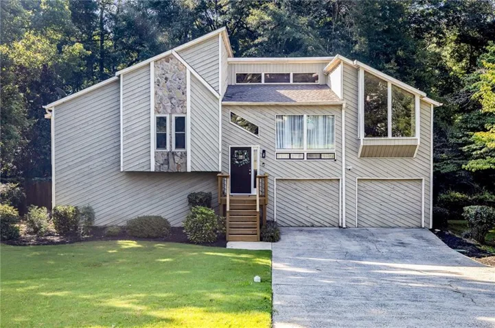 Contemporary exterior featuring stone accents and multiple large windows